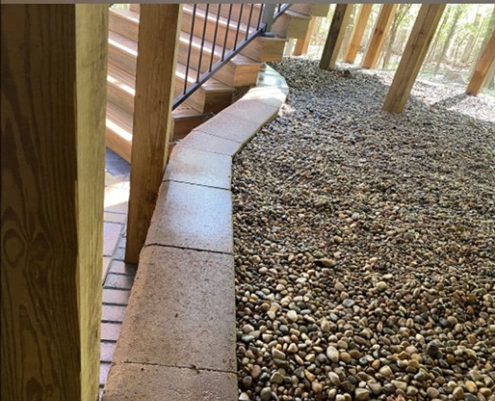 Curved stone pathway and wooden staircase in a nature setting. Ideal for outdoor landscaping.
